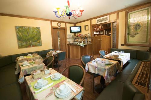 a restaurant with tables and chairs and a chandelier at Antica Villa Graziella in Marghera