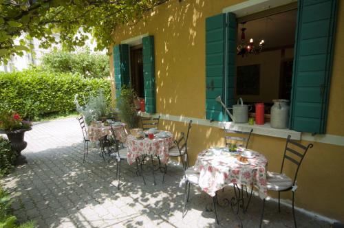 a patio with tables and chairs in front of a building at Antica Villa Graziella Venice - Atika & Atif in Marghera