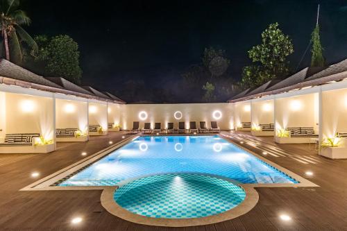 a swimming pool in a resort at night at Hakuna Maldives in Thoddoo