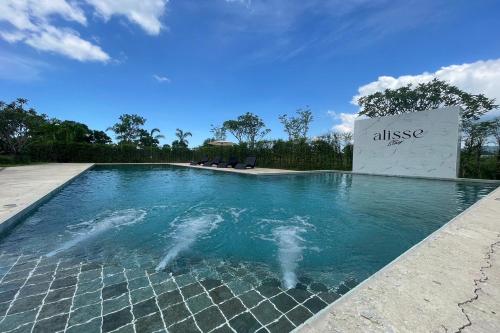a swimming pool with two dolphins in the water at Alisse Stay Phuket Layan in Phuket