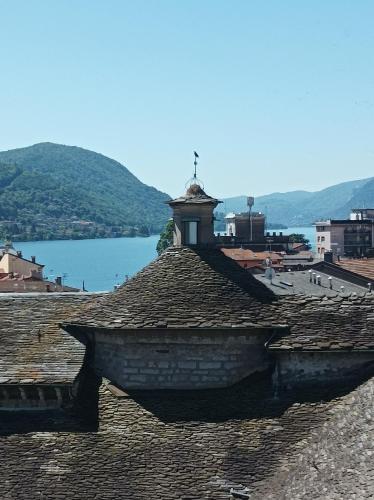 a roof with a clock tower on top of it at Lago d'Orta attico Sofia in Omegna