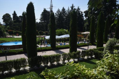 a garden with trees and a swimming pool at Casale al Foino in Induno Olona