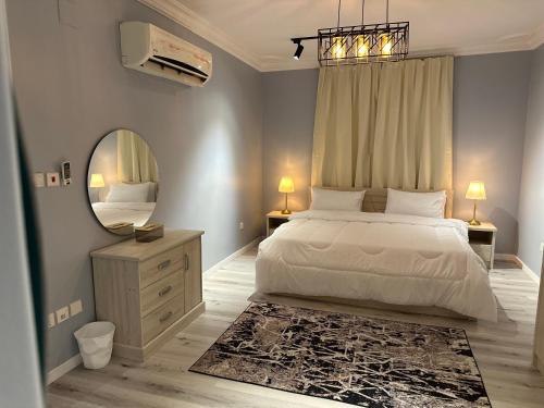a bedroom with a large bed and a mirror at شقة قباء r s 1 in Medina