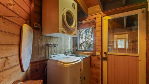 a small bathroom with a sink and a washing machine at Smoko in Dinner Plain