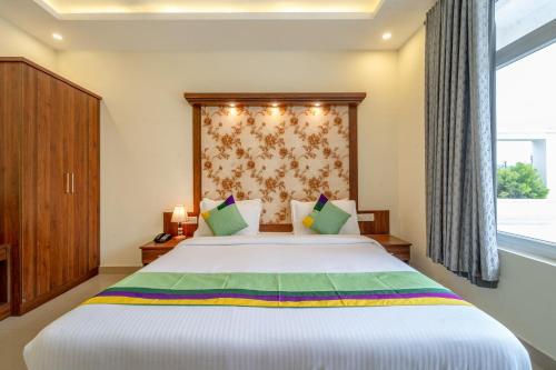 Ein Bett oder Betten in einem Zimmer der Unterkunft Treebo Windsong Resort Munnar, Tea Plantation View