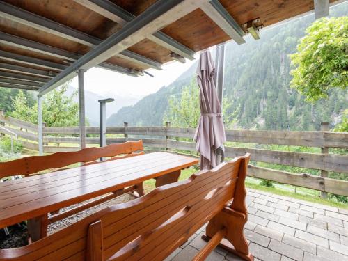two benches on a porch with a view of a mountain at Farmhouse in Tobadill with Mountain Views in Tobadill