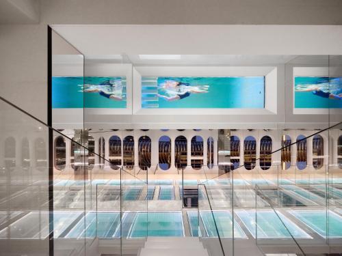 a pool in a building with a swimming pool at ISEYA Panoramic Hotel Chongqing Jiefangbei Raffles Plaza in Chongqing