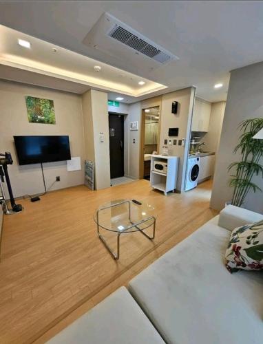 a living room with a couch and a glass coffee table at Elbon the stay with A1 in Busan