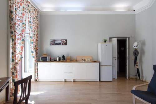 a kitchen with white cabinets and a refrigerator at GuestHouse o Affittacamere Magenta Baylon Suite in Rome
