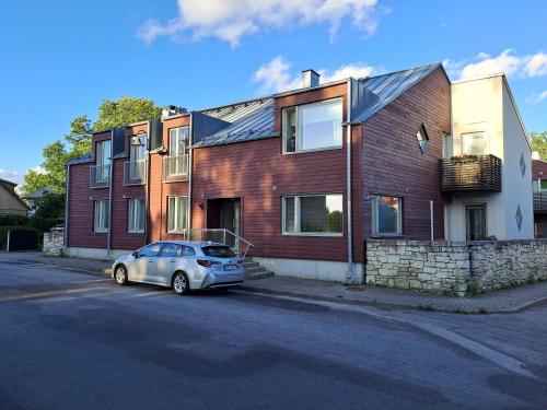 a small car parked in front of a house at Tolli 12 Apartment in Kuressaare