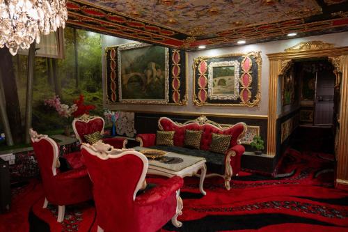 a living room with red chairs and a couch at Aparthotel AA in Sarajevo
