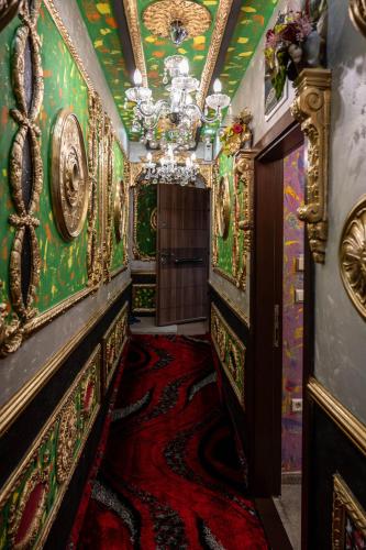 an ornate hallway with a chandelier and a room at Aparthotel AA in Sarajevo