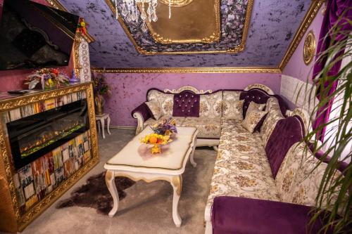 a room with a couch and a table and a fireplace at Aparthotel AA in Sarajevo
