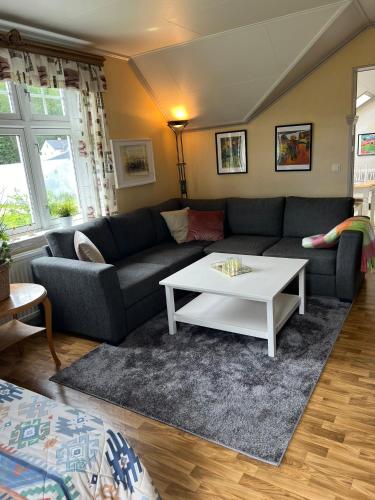 a living room with a couch and a coffee table at Rosa Huset Osebol in Stöllet