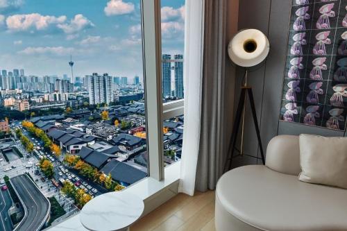 a room with a window with a view of a city at ISEYA Serviced Apart-ment Chengdu Taikoo Li Flagship in Chengdu