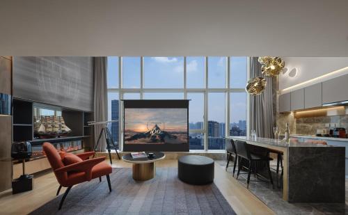 a kitchen and living room with a large window at ISEYA Serviced Apart-ment Chengdu Taikoo Li Flagship in Chengdu
