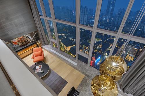 an overhead view of a living room with a large window at ISEYA Serviced Apart-ment Chengdu Taikoo Li Flagship in Chengdu