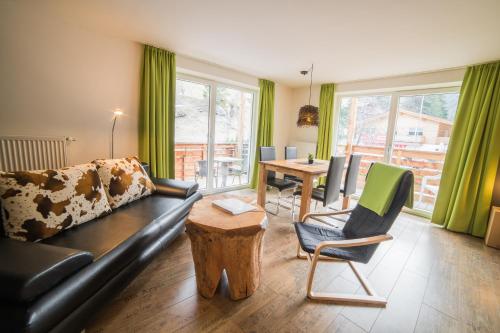 a living room with a couch and chairs and a table at Residence Martell Mountains in Martello