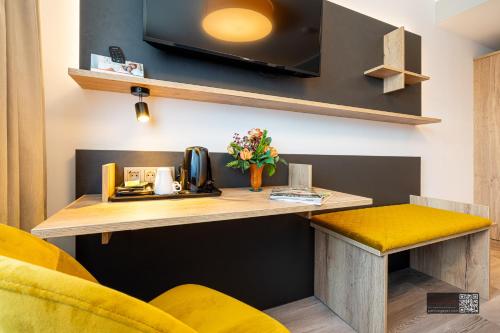 a room with a desk with a tv on the wall at Hotel Spahr in Stuttgart