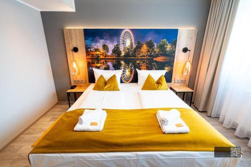a bedroom with a large bed with a painting on the wall at Hotel Spahr in Stuttgart