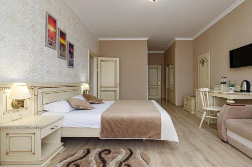 a hotel room with a bed and a couch at Hotel Podgorie Spa in Bukovel
