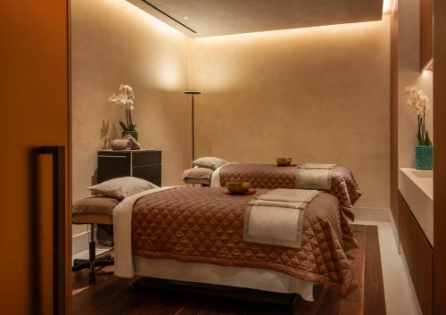 a bedroom with two beds in a room at San Domenico Palace, Taormina, A Four Seasons Hotel in Taormina
