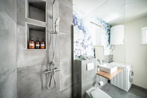 a bathroom with a shower with a toilet and a sink at Apartman Margareta in Matulji