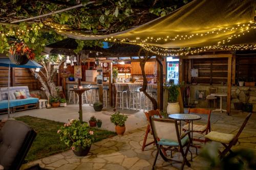 a patio with a table and chairs and lights at T H E BERLIN Studios and Suites in Nea Vrasna