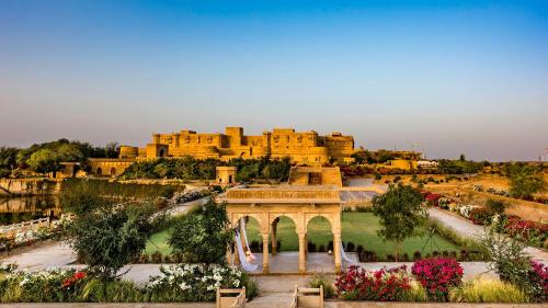 a view of a large building with a garden at Suryagarh Jaisalmer in Jaisalmer