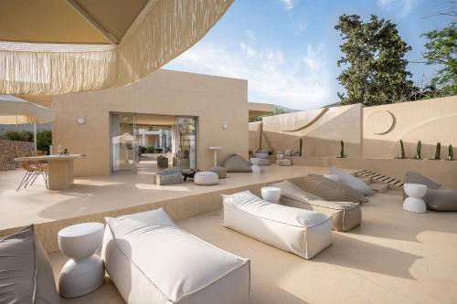 a living room with white couches and chairs at Sunshine Boutique Hotel by Estia in Malia