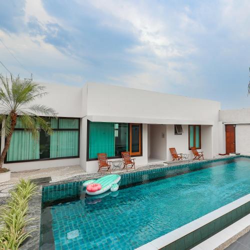 a swimming pool in a villa with a pool noodle in the middle at Da Xiang Villa with Private Pool in Chiang Mai in Chiang Mai