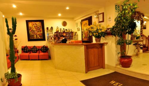 a lobby with plants and a counter in a store at Awki´s Dream Hotel in Cusco