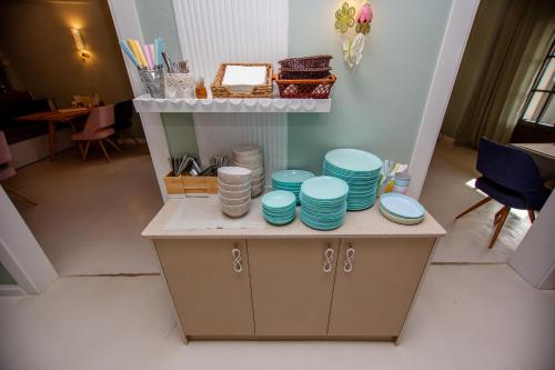 a table with blue bowls and plates on it at T H E BERLIN Studios and Suites in Nea Vrasna