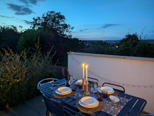 a table with a candle on top of a patio at LE CEMAROSE Cottage & Spa Terrace Garden & lovely View in Épernay