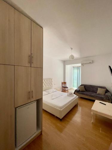 a living room with a bed and a couch at Keivi Guesthouse in Sarandë