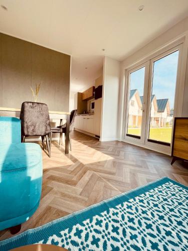 a living room with a table and a dining room at New Corner Holiday Camp in Niechorze