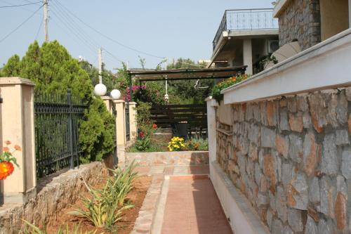 a stone wall with a walkway in front of a house at Studio in Selínia