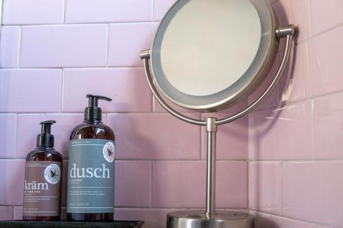 a mirror next to two bottles on a counter at Ballerina Bianca bed & breakfast in Grottazzolina