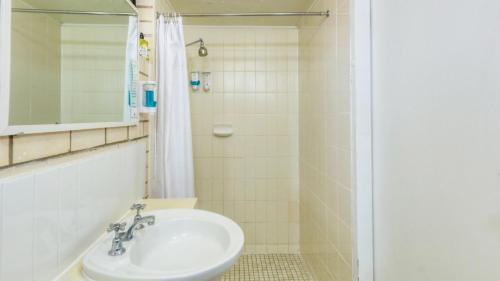a bathroom with a sink and a shower at Tropical Gateway Motor Inn in Rockhampton