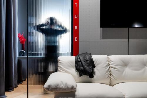 a living room with a white couch and a shadow at Interno Marche Design Experience Hotel in Tolentino