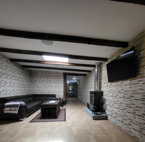 a living room with a couch and a brick wall at CASA D´PEPE in Meis