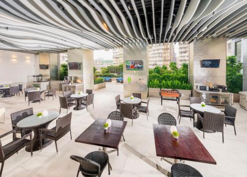 a restaurant with tables and chairs in a building at iclub To Kwa Wan Hotel in Hong Kong