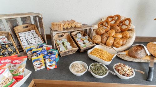 a table topped with lots of different types of bread at Huberhof in Ruhpolding