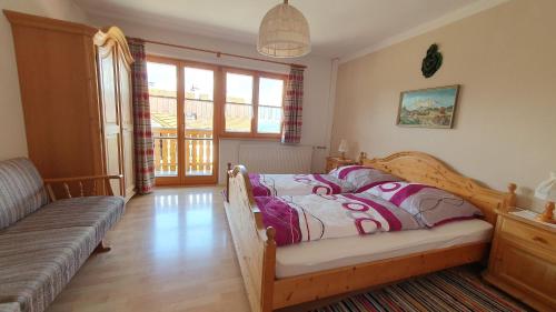 a bedroom with a bed and a couch at Ferienhaus Oberirlerhof in Anger