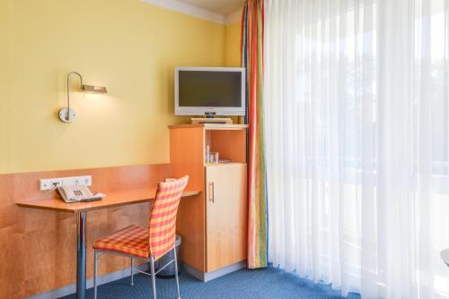 TV a/nebo společenská místnost v ubytování Hotel Beim Schrey