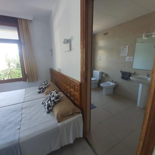 a bedroom with a bed and a sink and a toilet at Hotel Bonsol ADULTS ONLY in Lloret de Mar