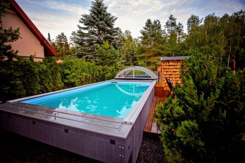 a swimming pool in the backyard of a house at Winiec Family Houses in Winiec