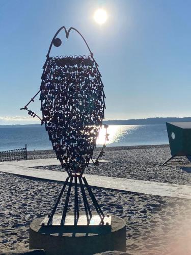 a sculpture of a fish on the beach at Meerzeit in Eckernförde