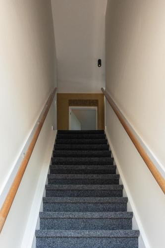 an empty stairs in a building with a hallway at Gezellig appartement in Burum