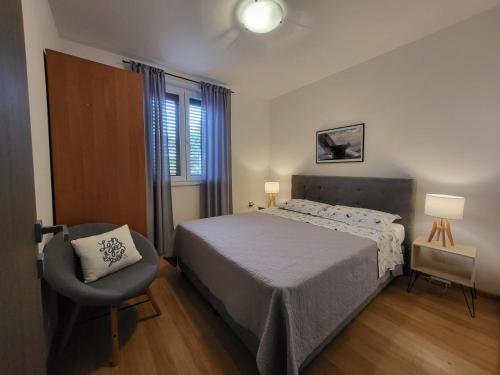 Posteľ alebo postele v izbe v ubytovaní Apartment Luciana